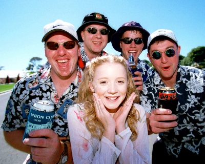 Melbourne Cup - Nikki Webster with some beer drinking boys. Photo by Simon Dallinger.
